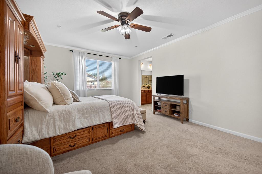 5409 Mill Water Circle Rancho Cordova, CA 95742 - Photo 31 of 48 a spacious bedroom with a bed and a flat screen tv