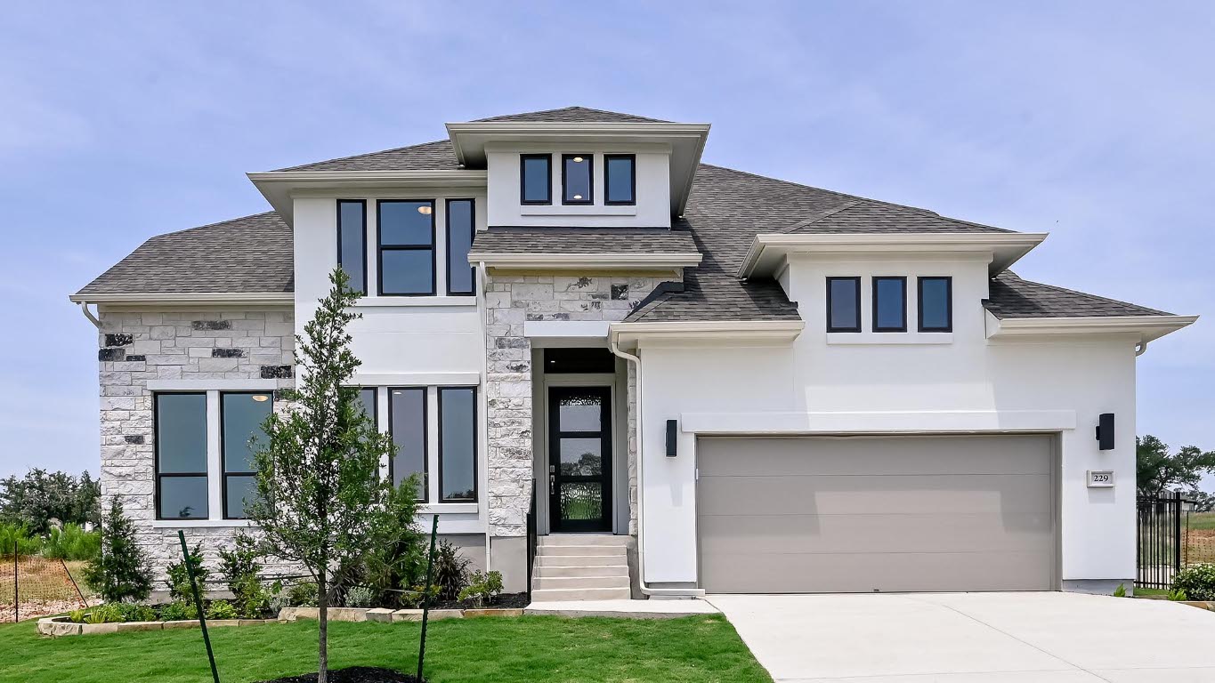 229 Leaning Rock Ridge Austin, TX 78737 - Photo 1 of 1 View of front of house featuring stucco siding, driveway, stone siding, and a shingled roof