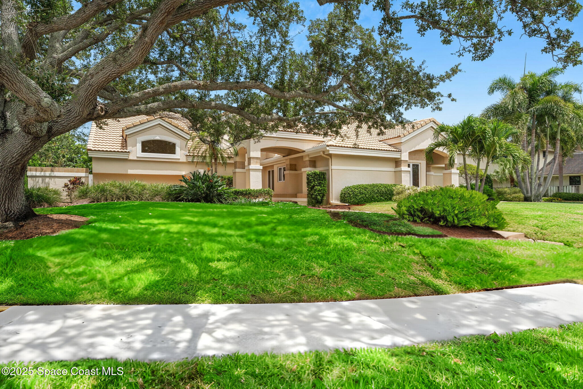 a front view of a house with a garden
