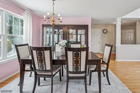a view of a dining room with furniture wooden floor and chandelier