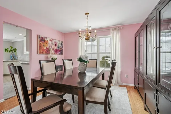 a view of a dining room with furniture wooden floor and chandelier