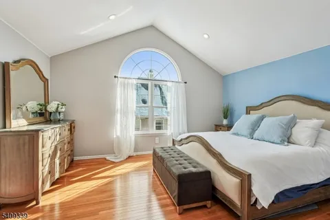 a bedroom with a bed and a mirror