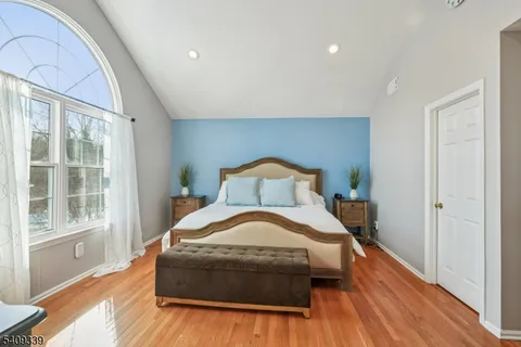 a bedroom with a bed and a large window