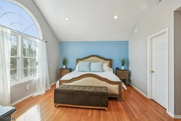 a bedroom with a bed and a large window