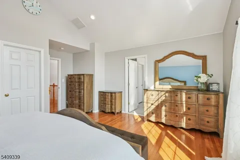 a bedroom with a bed and a dresser