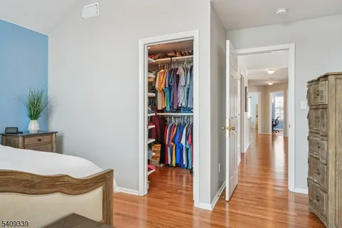 a view of a hallway with wooden floor and entryway