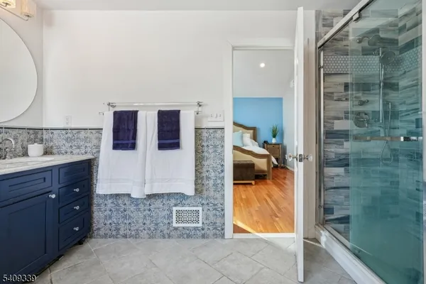 a bedroom with a bed a chair and a large window