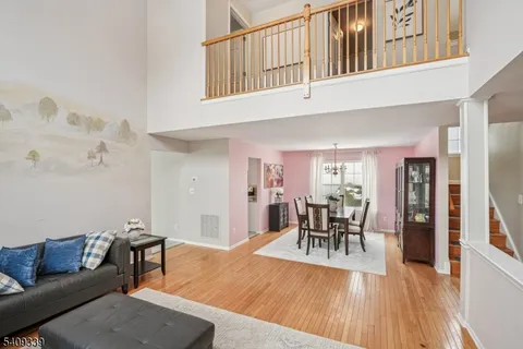 a living room with furniture dining table and wooden floor
