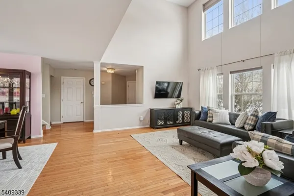 a living room with furniture dining table and wooden floor
