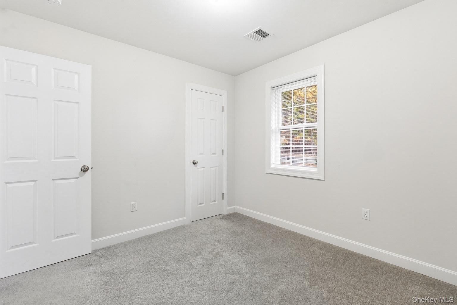 130 Beaver Dam Road Brookhaven, NY 11719 - Photo 11 of 15 an empty room with windows
