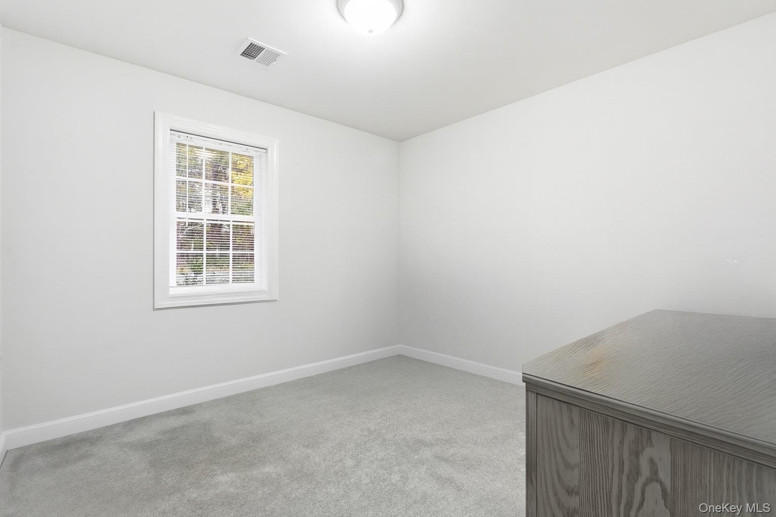 130 Beaver Dam Road Brookhaven, NY 11719 - Photo 12 of 15 an empty room with a window