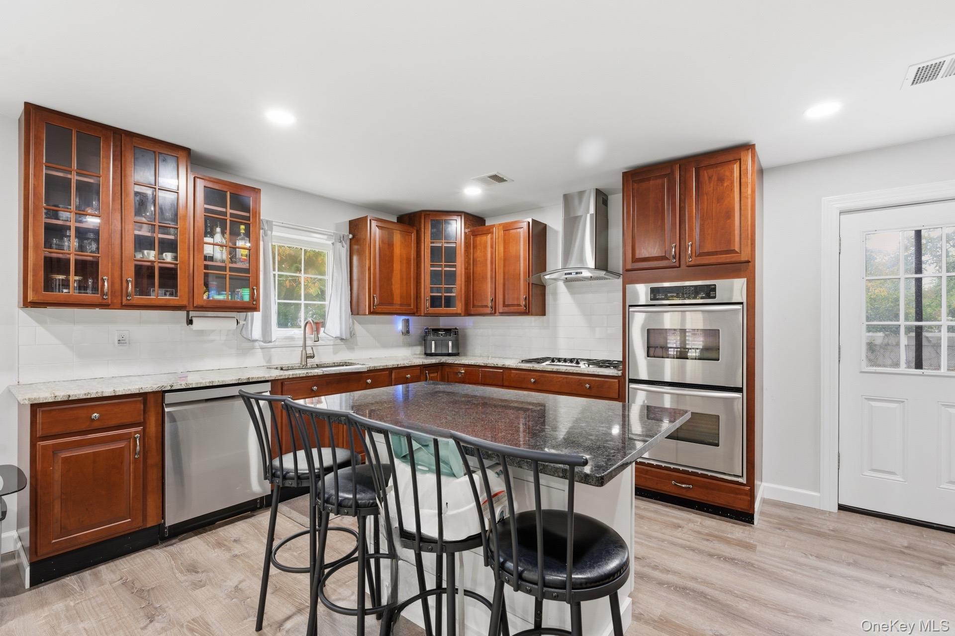 130 Beaver Dam Road Brookhaven, NY 11719 - Photo 3 of 15 a kitchen with stainless steel appliances granite countertop a stove a sink and a refrigerator