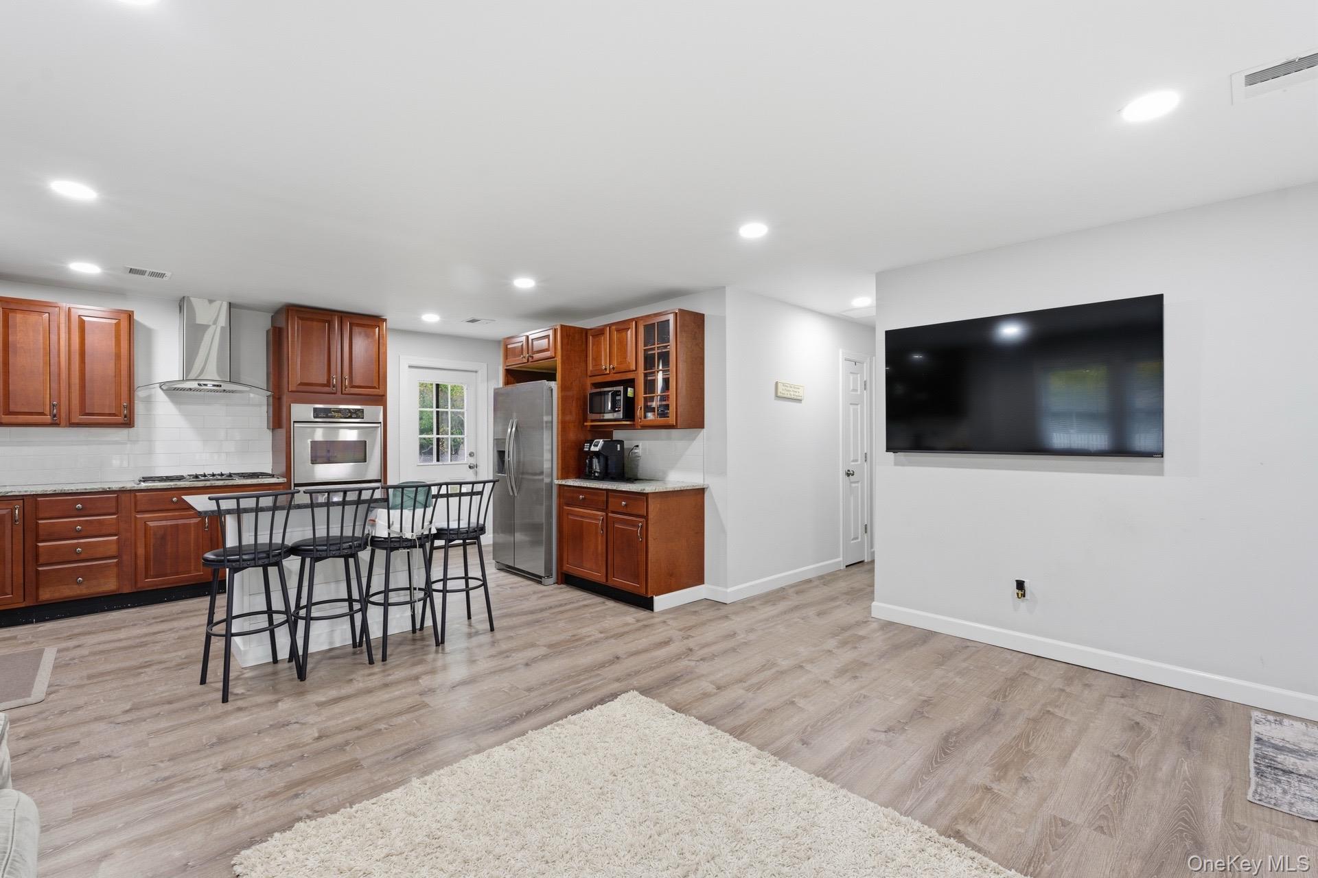 130 Beaver Dam Road Brookhaven, NY 11719 - Photo 7 of 15 a living room with furniture and a flat screen tv