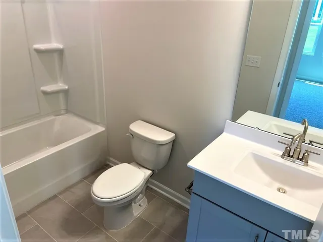 a white toilet sitting next to a bathroom sink