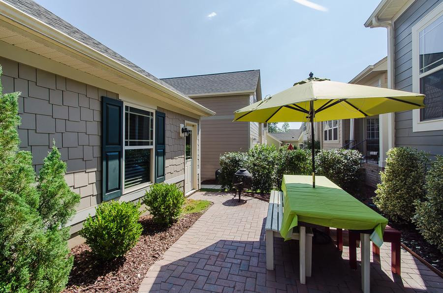 1407 Van Page Boulevard Raleigh, NC 27607 - Photo 22 of 25 Relax outside with included landscaping on this luxurious brick paver patio. This yard backs to one of two neighborhood pocket parks. Patio/Deck