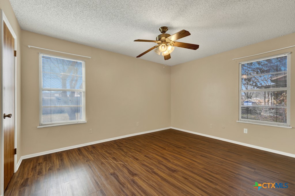 217 Gruene Road New Braunfels, TX 78130 - Photo 11 of 25 wooden floor in an empty room with a window