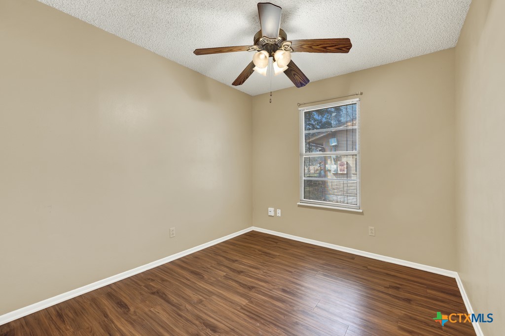 217 Gruene Road New Braunfels, TX 78130 - Photo 14 of 25 a view of an empty room with wooden floor and a window