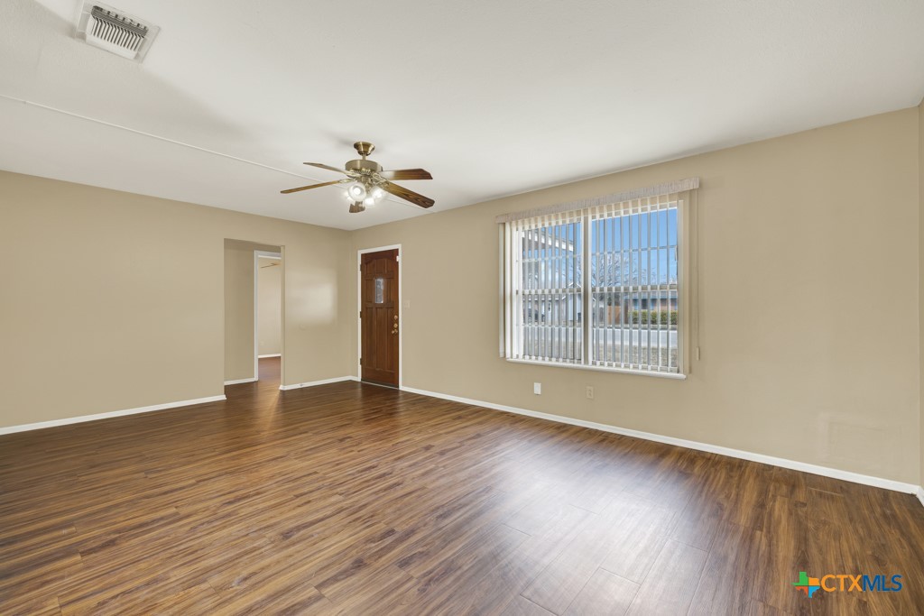217 Gruene Road New Braunfels, TX 78130 - Photo 3 of 25 a view of an empty room with wooden floor and a window