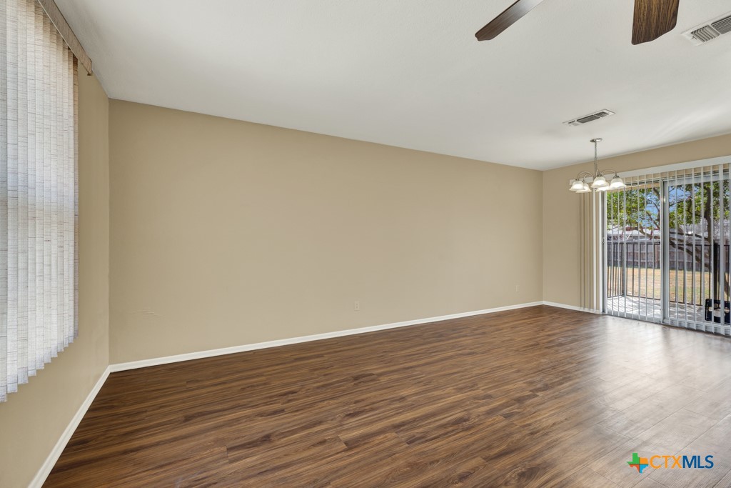 217 Gruene Road New Braunfels, TX 78130 - Photo 6 of 25 a view of an empty room with wooden floor and a window