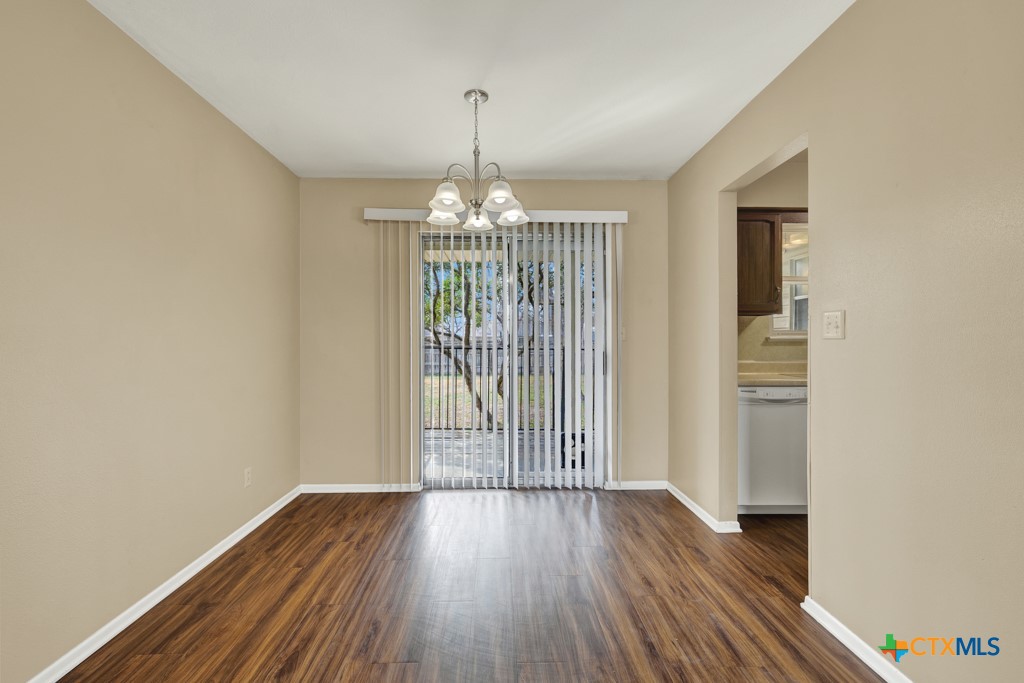 217 Gruene Road New Braunfels, TX 78130 - Photo 8 of 25 a view of a room with wooden floor chandeliers and kitchen