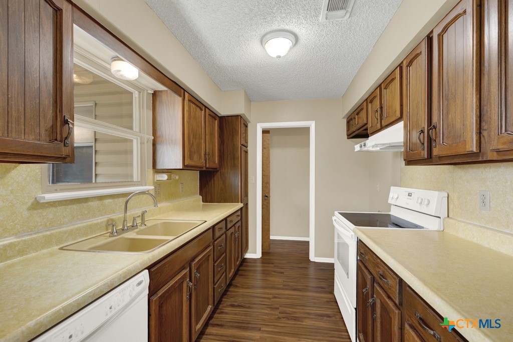 217 Gruene Road New Braunfels, TX 78130 - Photo 9 of 25 a kitchen with a sink stove and cabinets