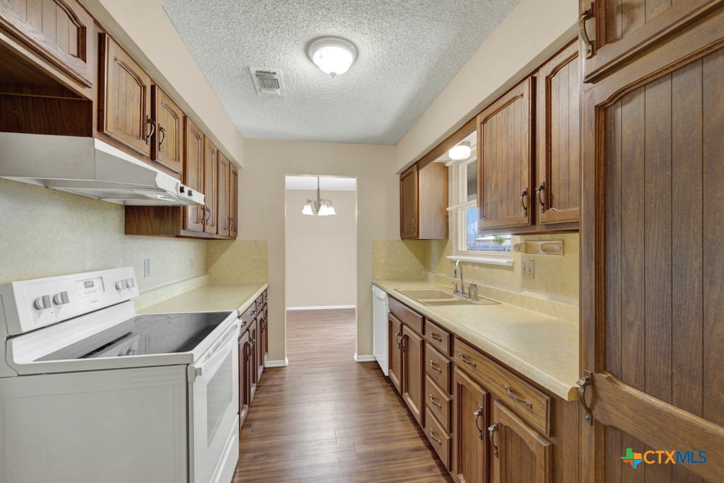 217 Gruene Road New Braunfels, TX 78130 - Photo 10 of 25 a kitchen with a sink a stove and cabinets