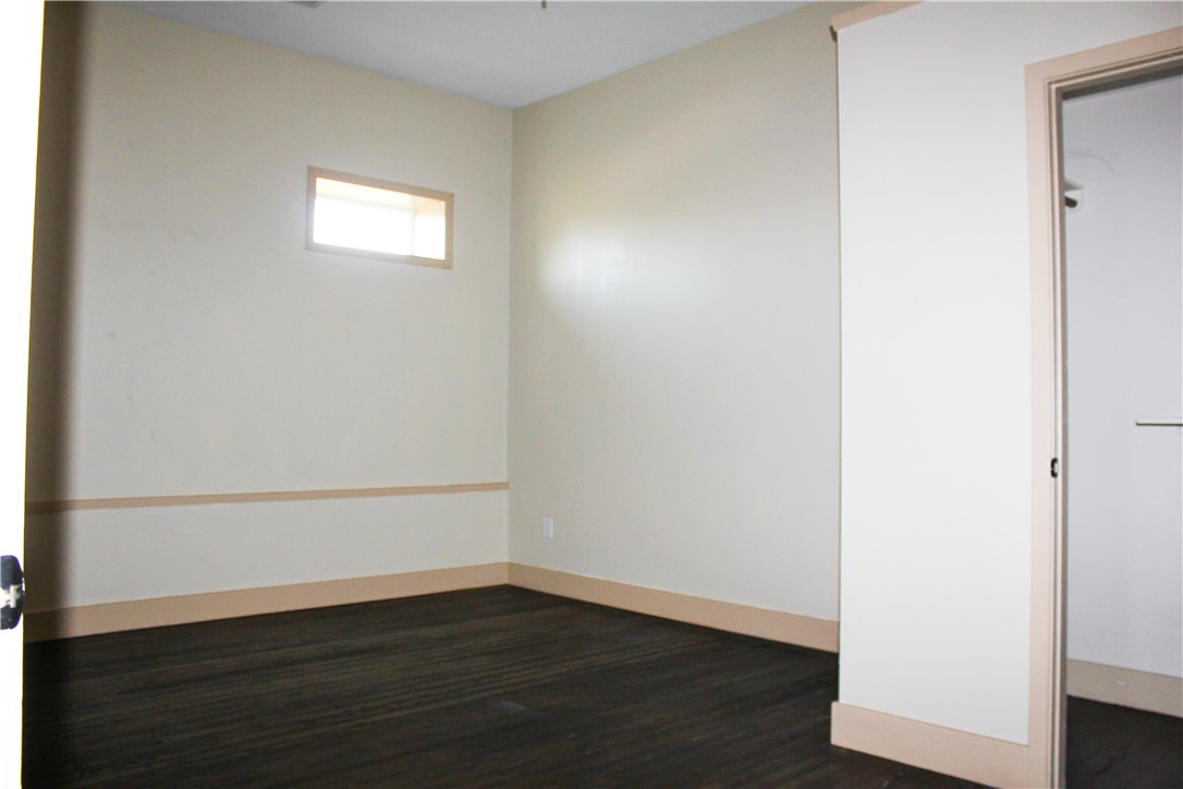 205 South Main Street Caldwell, TX 77836 - Photo 9 of 12 a view of an empty room with wooden floor and a window