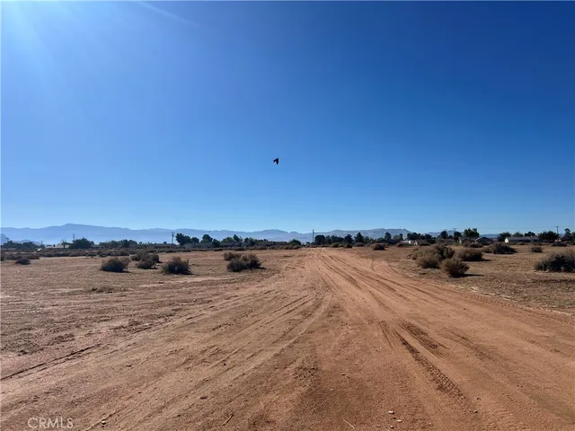 a view of a car parked in front of a house with a yard