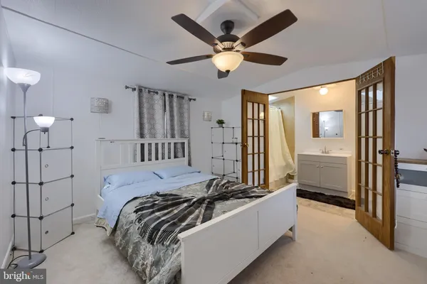 a bed room with a bed and a chandelier