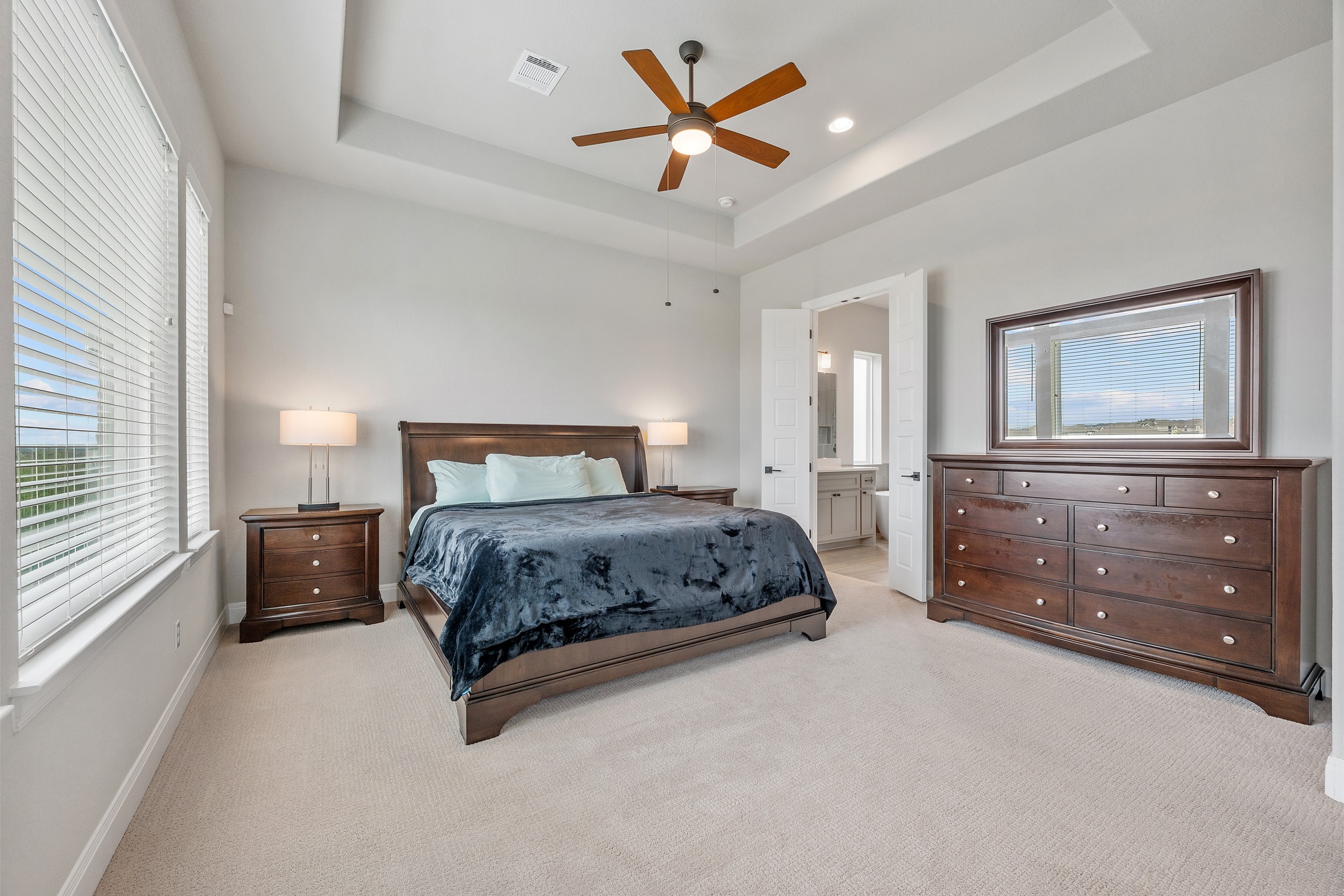 510 Elworth Path Austin, TX 78738 - Photo 11 of 40 a bedroom with a large bed and a chandelier