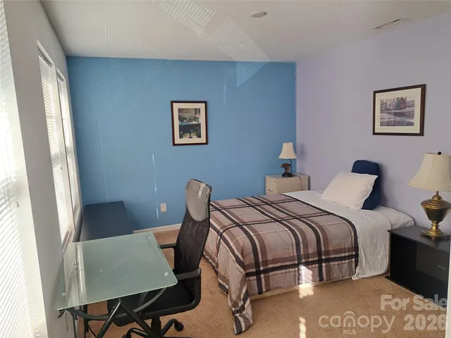 a bedroom with a bed and a table in it