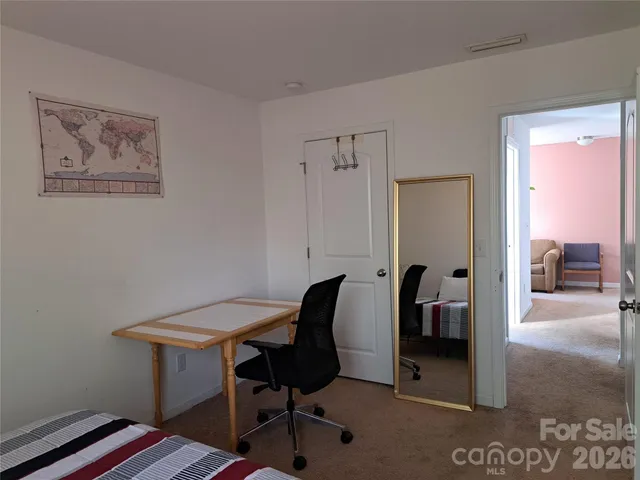 a view of a workspace with furniture and a gate
