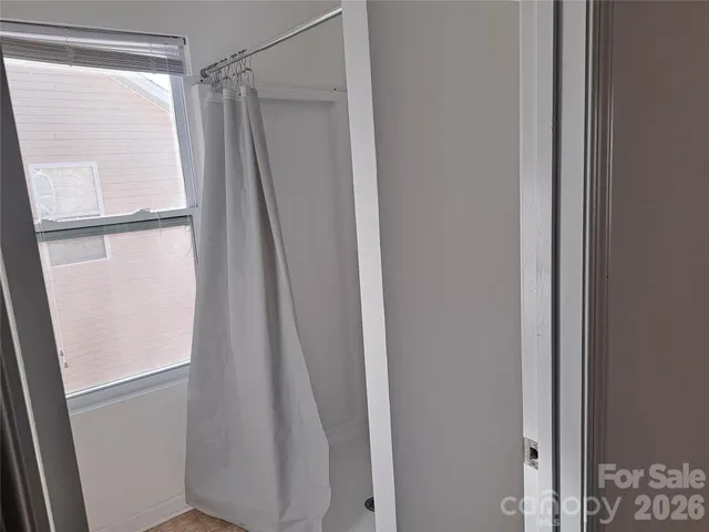 a bathroom with a glass shower door
