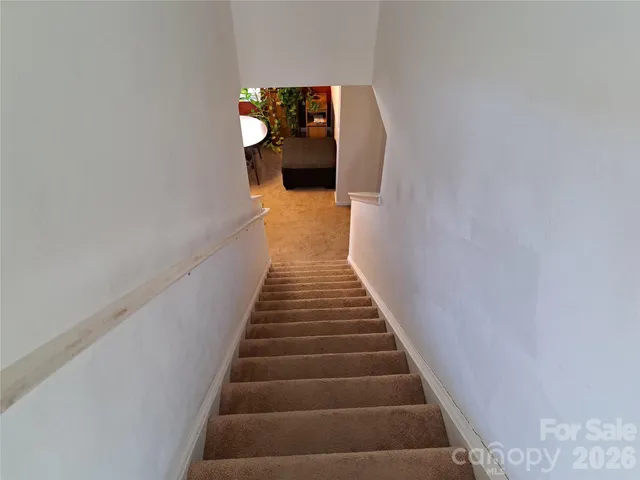 a view of a hallway with wooden floor and entryway