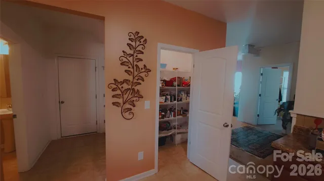 a room with a teddy bear on a bed