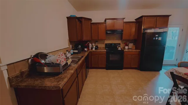 a kitchen with a refrigerator and stove