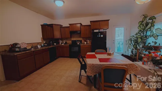 a kitchen with a table and chairs in it