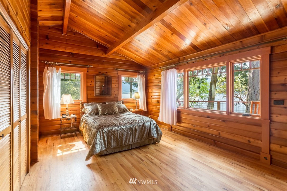 1485 East Sequim Bay Road Sequim, WA 98382 - Photo 11 of 25 a bedroom with furniture and large windows