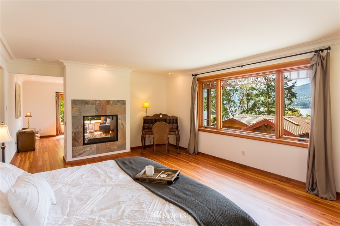 1485 East Sequim Bay Road Sequim, WA 98382 - Photo 16 of 25 a bedroom with furniture and a fireplace