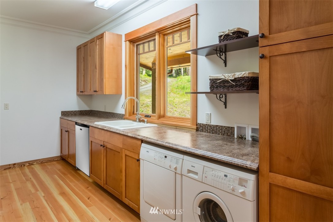 1485 East Sequim Bay Road Sequim, WA 98382 - Photo 18 of 25 a utility room with stainless steel appliances granite countertop a sink and a wooden floor