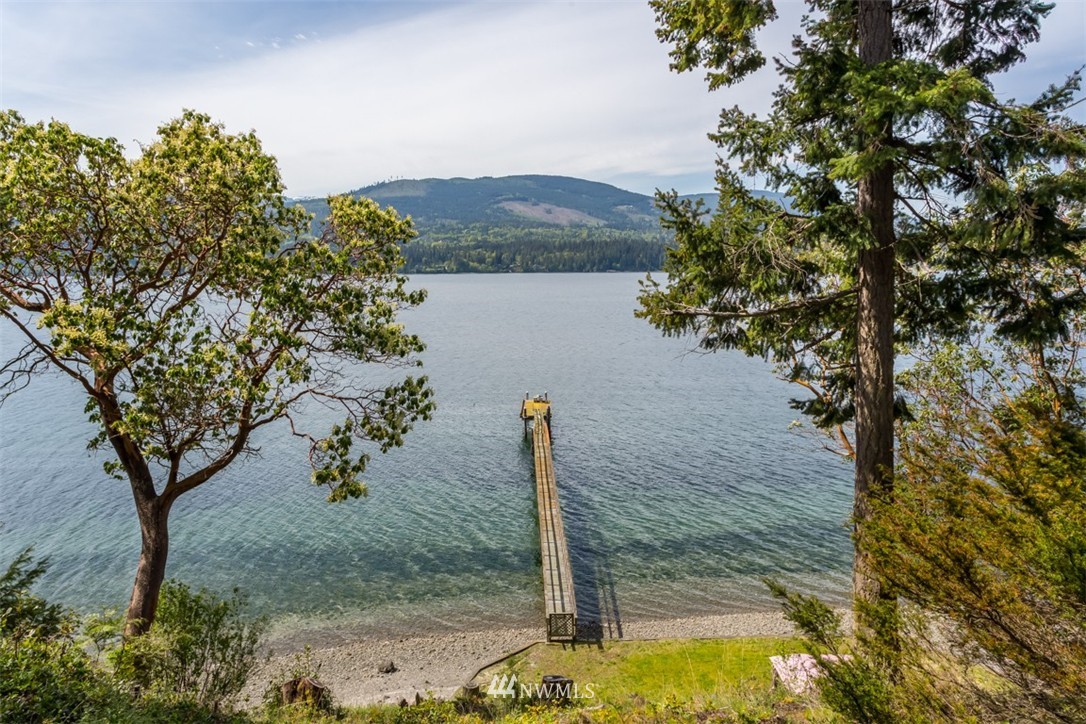 1485 East Sequim Bay Road Sequim, WA 98382 - Photo 23 of 25 a view of a wooden house with a yard