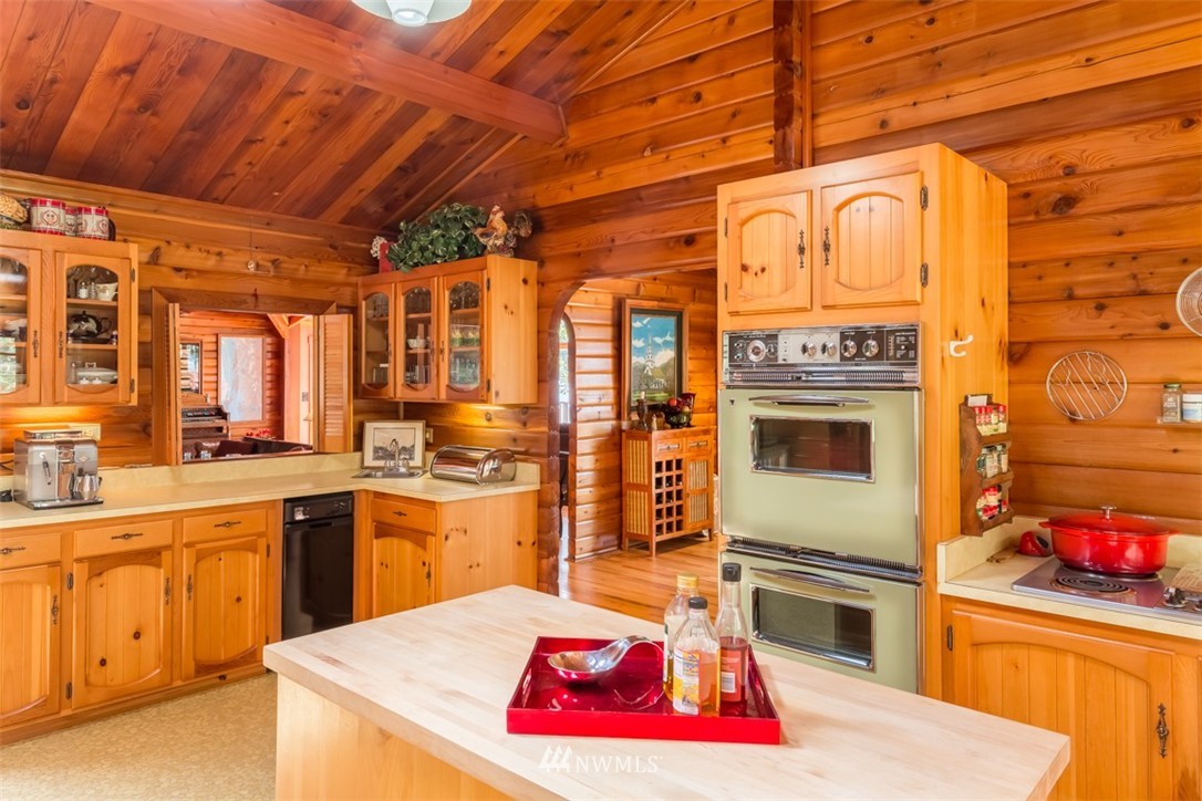 1485 East Sequim Bay Road Sequim, WA 98382 - Photo 8 of 25 a kitchen with stainless steel appliances kitchen island granite countertop a stove a sink and dishwasher