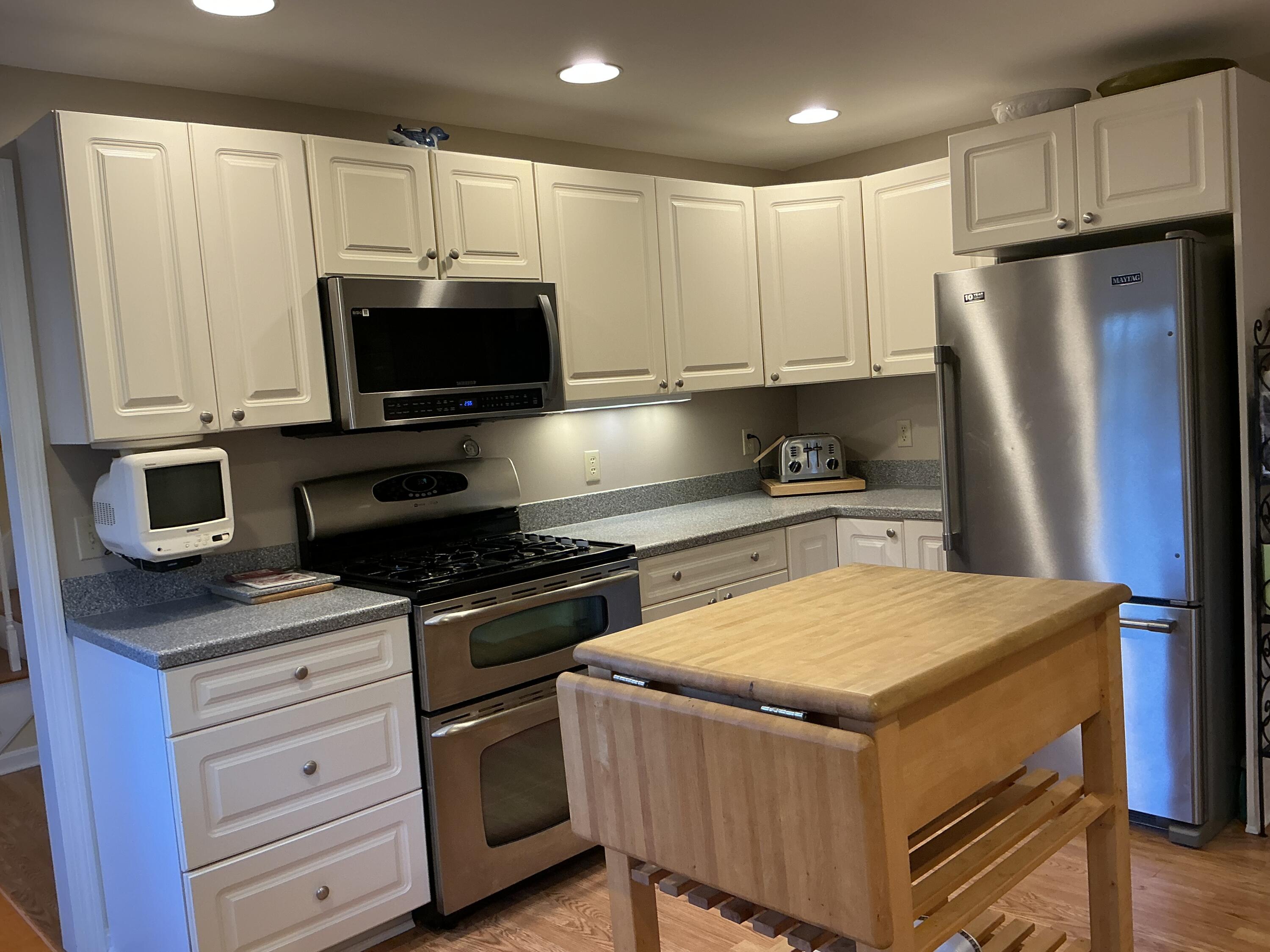 544 Cotuit Road Marstons Mills, MA 02648 - Photo 14 of 52 a kitchen with granite countertop a refrigerator stove and microwave