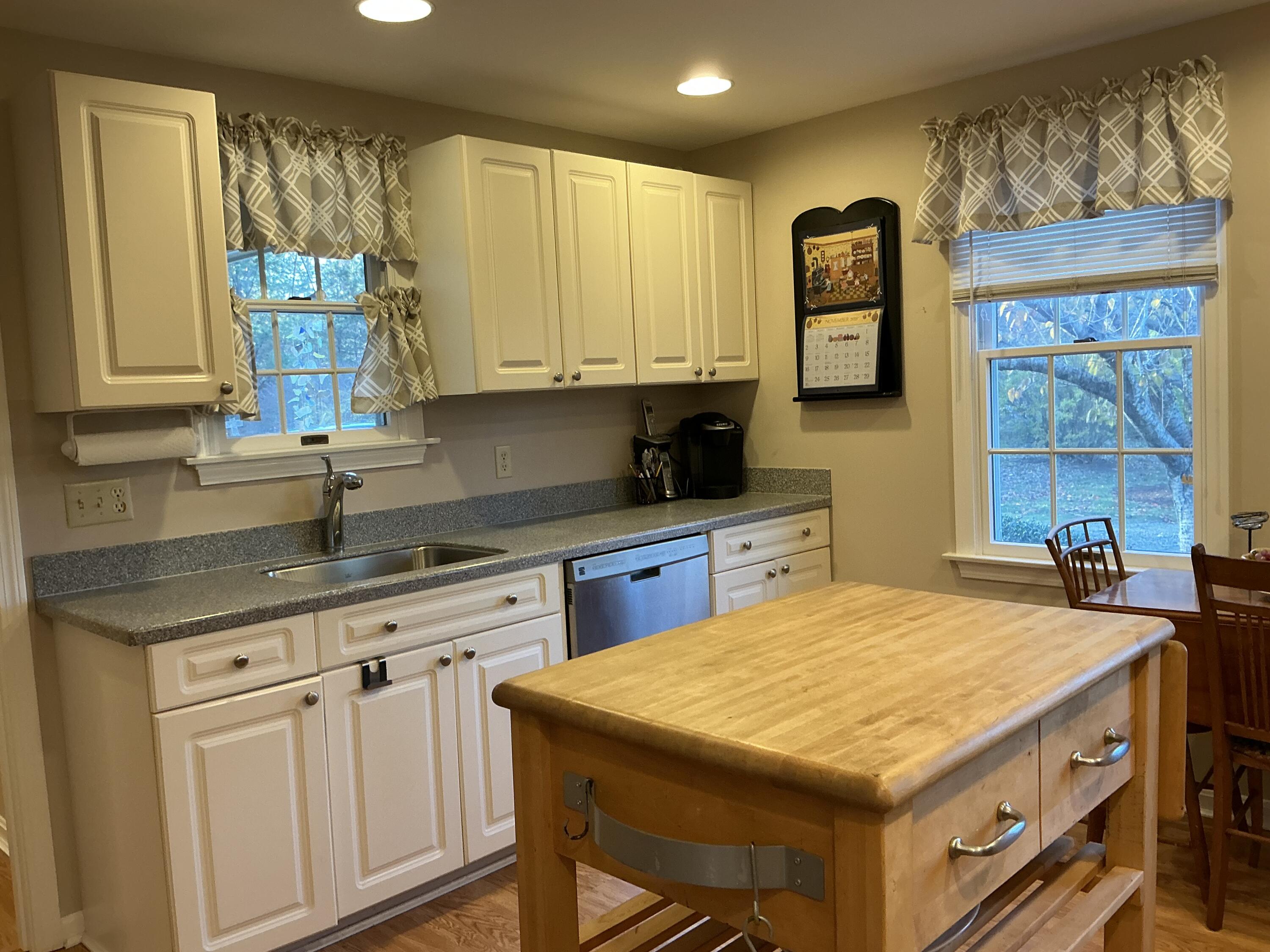 544 Cotuit Road Marstons Mills, MA 02648 - Photo 15 of 52 a kitchen with a stove a sink a refrigerator and cabinets