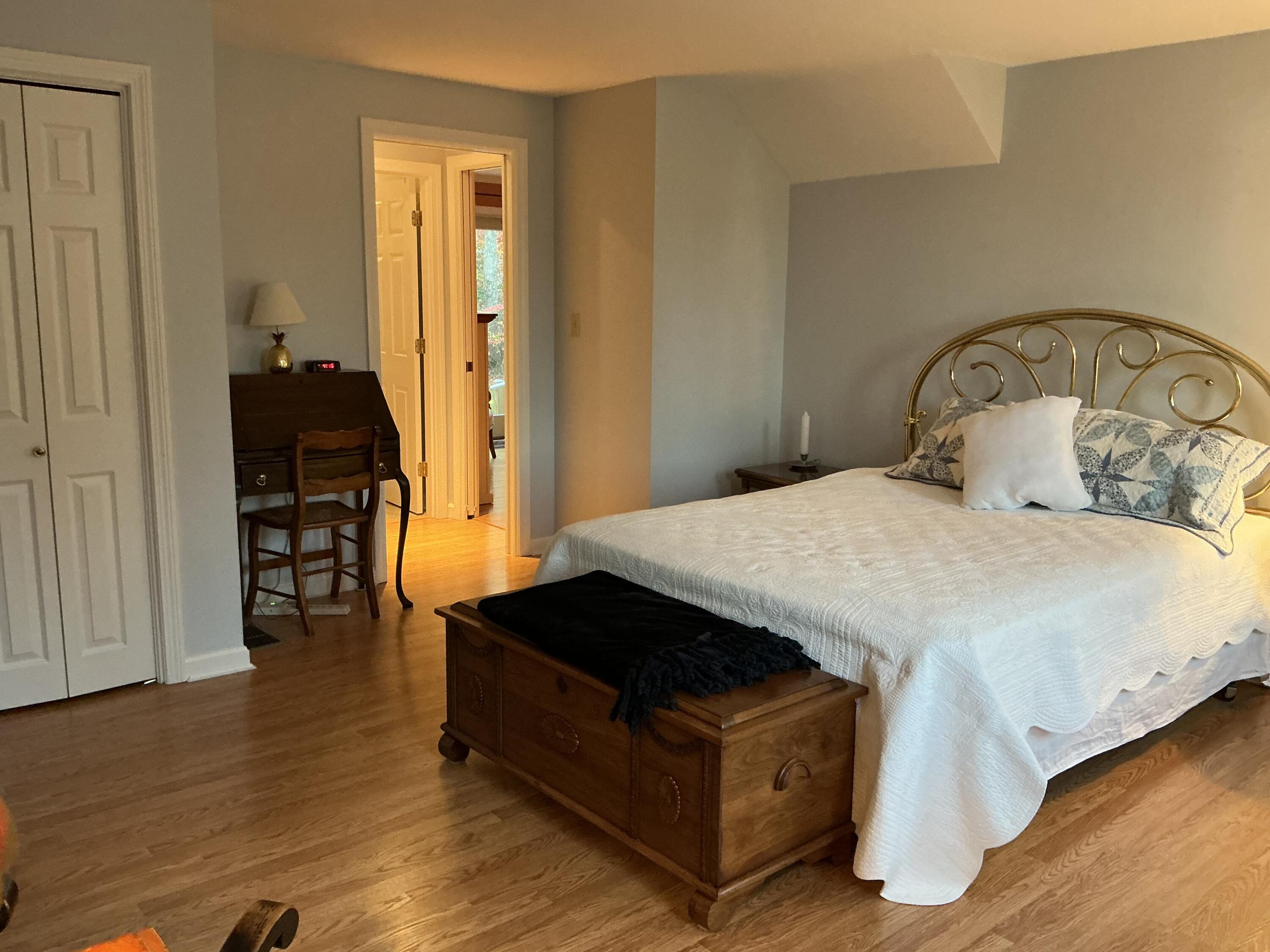 544 Cotuit Road Marstons Mills, MA 02648 - Photo 21 of 52 a bedroom with a bed and wooden floor