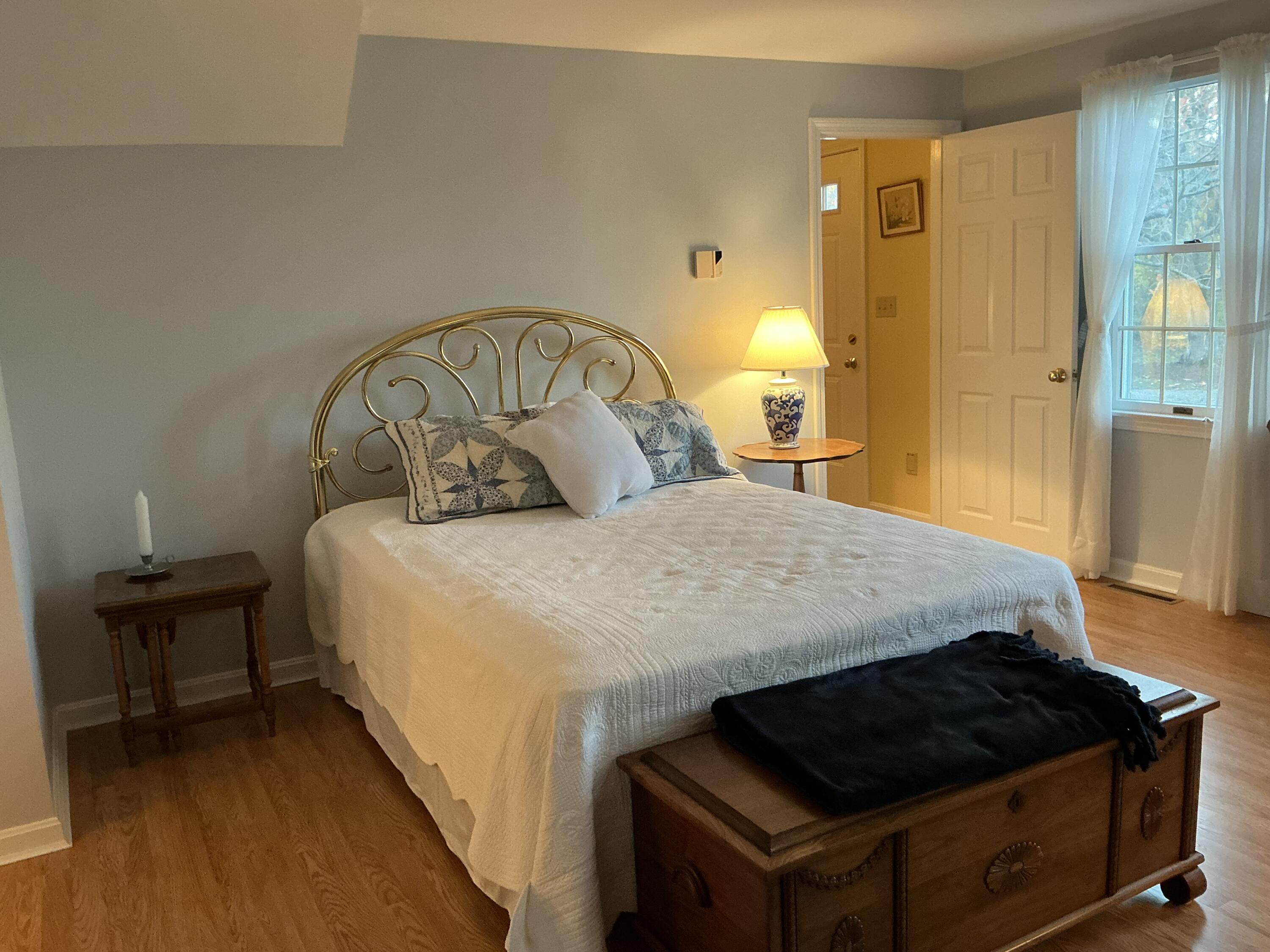 544 Cotuit Road Marstons Mills, MA 02648 - Photo 22 of 52 a bedroom with a bed and a table in it