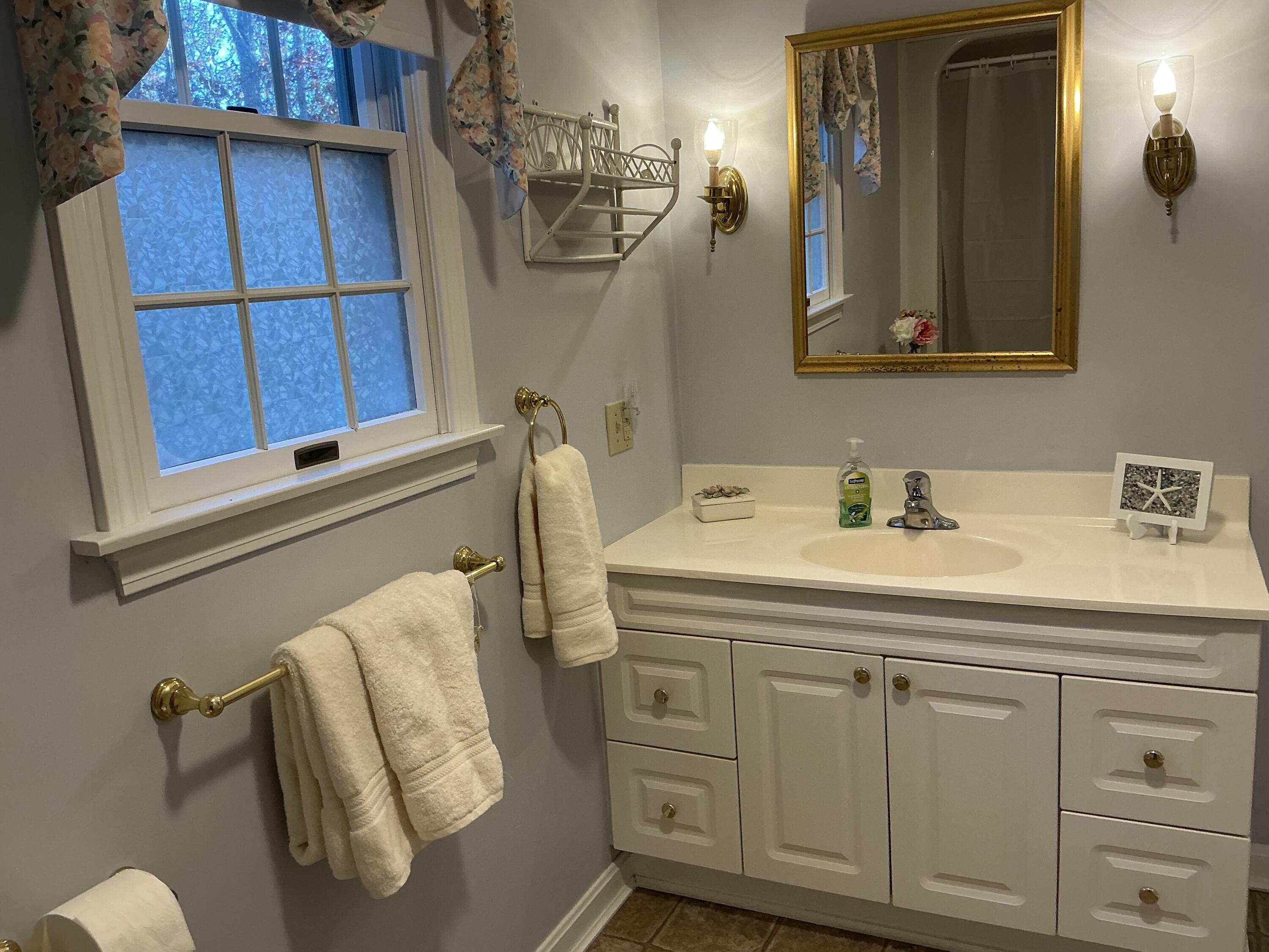 544 Cotuit Road Marstons Mills, MA 02648 - Photo 23 of 52 a bathroom with a sink and a mirror