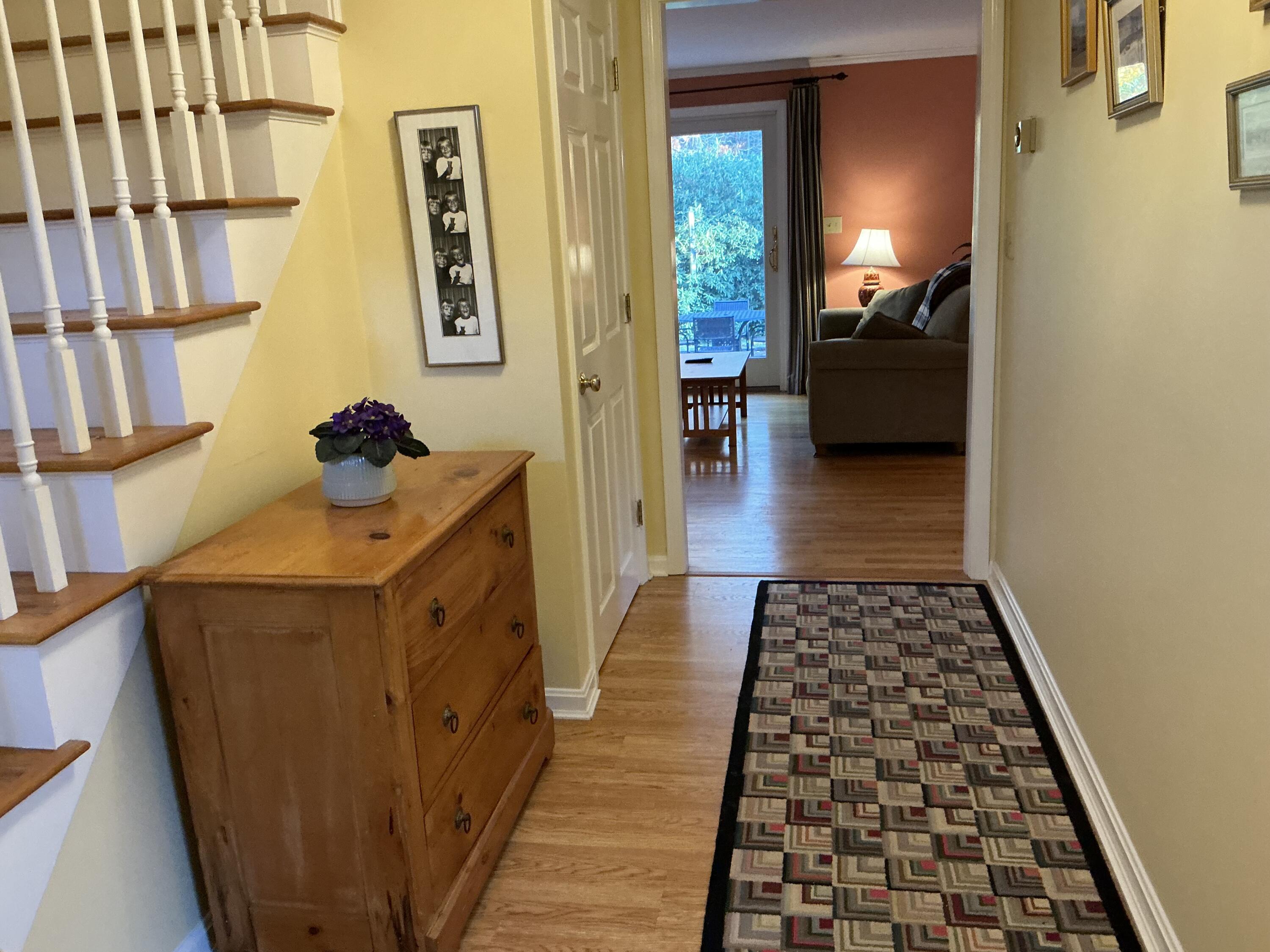 544 Cotuit Road Marstons Mills, MA 02648 - Photo 5 of 52 a hallway with black cabinets and wooden floor