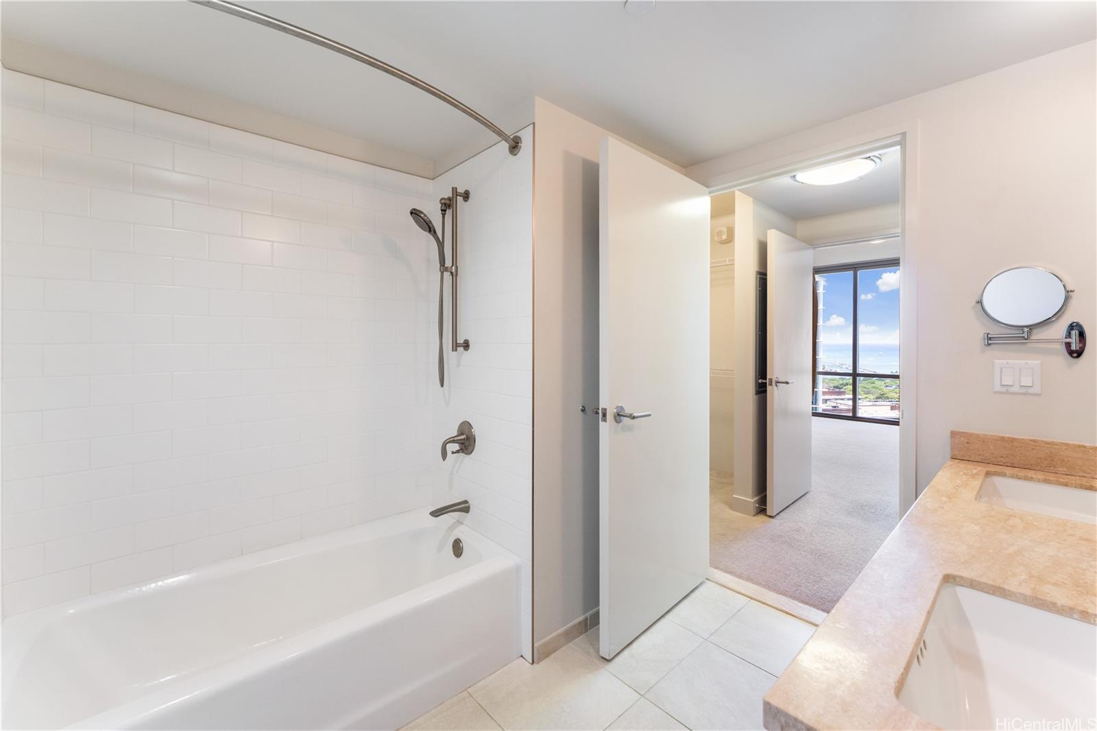 1189 Waimanu Street, Unit 2204 Honolulu, HI 96814 - Photo 8 of 17 a bathroom with a bathtub and a shower