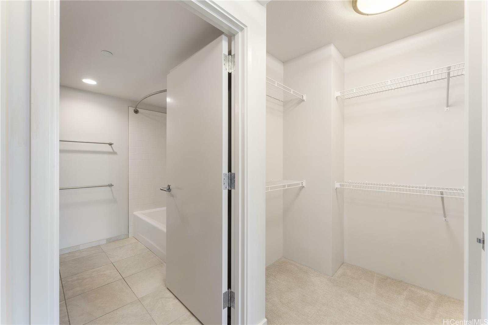 1189 Waimanu Street, Unit 2204 Honolulu, HI 96814 - Photo 9 of 17 a bathroom with a granite countertop sink a toilet and shower
